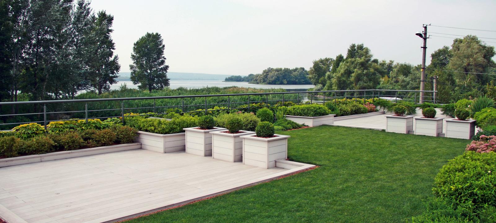 Roof garden with lawn and planters by the riverside